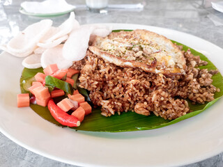 a plate of special fried rice made by a skilled chef, served on an aesthetic wooden table