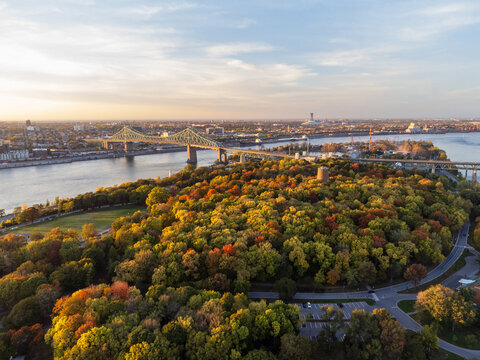 Aerial view of Jean-Drapeau Park, Saint Helen's Island in autumn sunset time. St. Lawrence River, Jacques Cartier Bridge in the background. Montreal, Quebec, Canada.