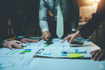 Business people meeting overtime, brainstorming, discussing, analyzing and planning business...