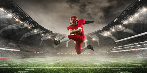 Football player in red uniform is caught mid-air as he leaps high, holding ball tightly, with stadium in background. 3D render of stadium. Concept of sport, tournament, competition, game event