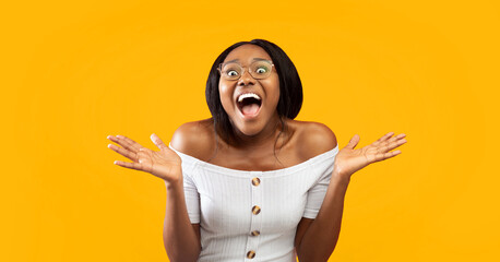 Excited Black Lady Screaming Looking At Camera Holding Hands Near Face Standing On Orange...