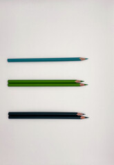 Colorful sharpened pencils are lined up on the table.