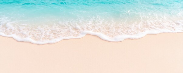 Beautiful tropical white sand beach with foam waves and a transparent sea, seen from above.