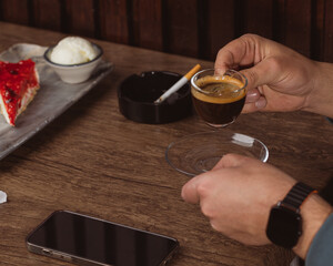 person holding a cup of espresso
