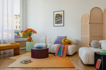 Modern sofa with textured cushions, a striking knot pillow, and bold artwork creating a unique...