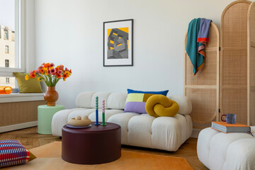 Bright and cheerful living room with soft furniture, colorful cushions, and fresh flowers in modern...