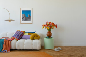 Stylish sofa setup with bold cushions and fresh flowers, creating a cheerful and inviting...