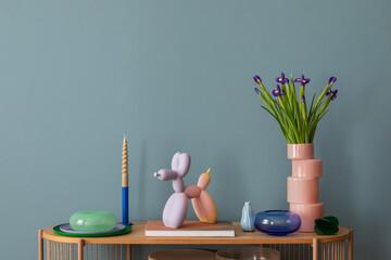 A harmonious display of colorful flowers, pastel candle holders, and quirky modern decor on a...