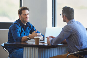 Meeting, laptop and business people in discussion at coffee shop for planning, conversation and talking. Professional, collaboration and men in restaurant on computer for feedback, review or teamwork