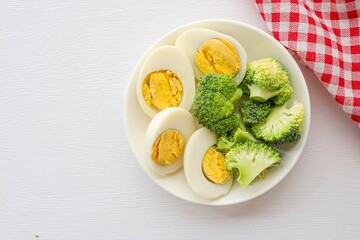 boiled eggs and  broccoli ,healthy food, diet food, on white background top view food table with free copy space