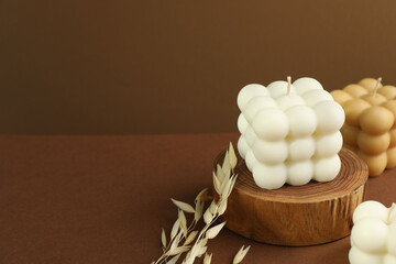 Beautiful bubble candles and spikes on brown table