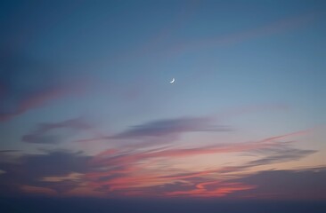 A serene evening sky with a crescent moon and plenty of room to copy the image. Night landscape.