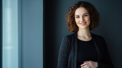 Confident pregnant businesswoman smiling indoors for professional maternity portrait