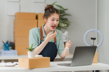 Ecommerce Success: An excited young entrepreneur celebrates a major milestone while working in her home office. The image exudes a sense of accomplishment and the joy of entrepreneurship.  