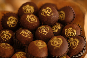box of chocolates, box of chocolate candies, brazilian sweet, brigadeiro, sweet with gold detail, top view

