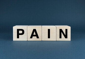 A close-up image of wooden blocks spelling out the word PAIN