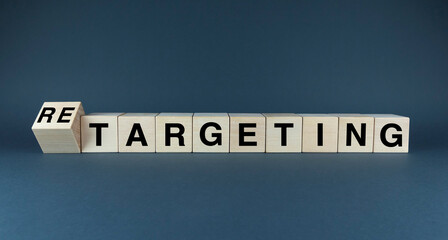 A conceptual image comparing the words TARGETING and RETARGETING on wooden blocks
