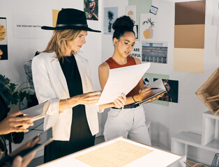 Creative business, women or brainstorming in workshop for design, advice or discussion at light box. Fashion designers, team or planning on paper for creativity, startup growth or ideas for clothing