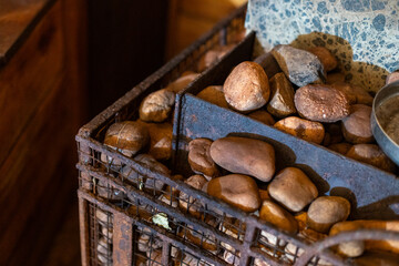 A rustic metal basket filled with natural river stones is a charming home decor addition