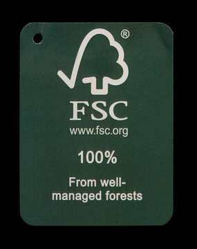 FSC - Forest Stewardship Council - logotype on used green cardboard tag. 100 percent from well-managed forests. Close up photo isolated on black background. Copenhagen, Denmark - September 9, 2024.