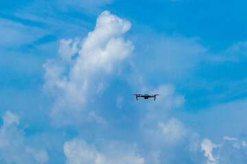 Flying and landing drone with blue sky in Mexico.