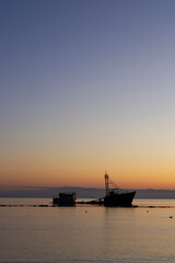 a sunken ship on a beach at sunset in Chile