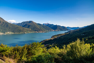 View of Lake Como, towards the south, from Musso, with the overhanging mountains, Dervio, the roads and the towns bordering the lake.
