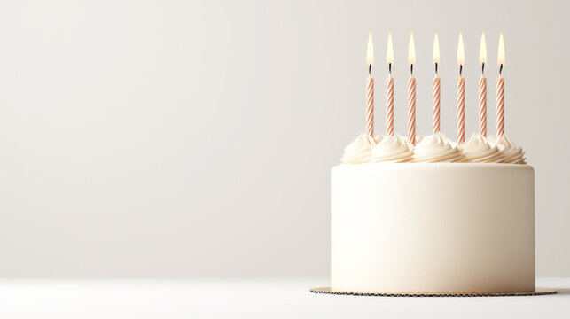 A simple and elegant birthday cake with lit candles, perfect for celebrations and festive occasions.