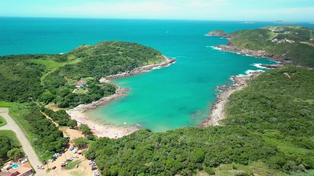 Aerial shot of Praia do Forno in Buzios, surrounded by lush hills and calm waters.