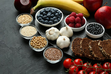 Different fresh products on black table. Source of prebiotics