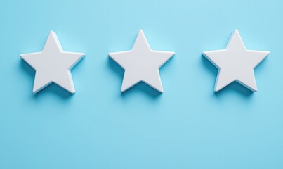 Obraz premium Three white stars arranged neatly on a light blue background, symbolizing ratings, reviews, or excellence in design.