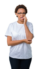 Beautiful young african american woman wearing glasses over isolated background looking stressed and nervous with hands on mouth biting nails. Anxiety problem.