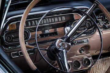 Oldschool interior of American Oldtimer car - visible speedometer and steering wheel