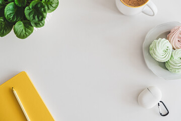 Mock-up with tablet, smartphone, notebook, coffee cup, food and plant on white table. Top view. Flat lay