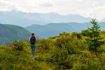  woman hiker hiking outdoors.  concept of ecotourism in conservation.