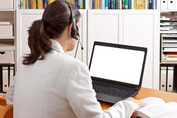Telemedicine concept: doctor or pharmacist with headset during a video call with another doctor...
