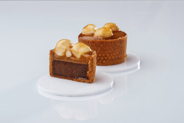 Caramel tart with walnut against white background