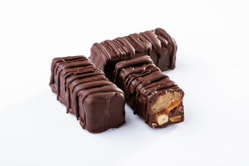 Chocolate bars lie on a white surface, isolated