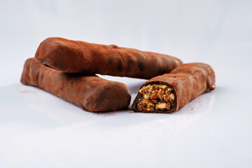 Brown colored chocolate bars lie on a white surface, isolated