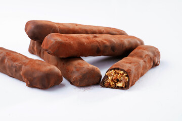 Chocolate bars lie on a white surface, isolated