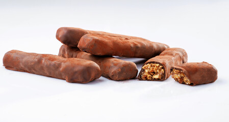 Brown colored chocolate bars lie on a white surface, isolated