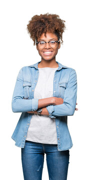 Beautiful young african american woman wearing glasses over isolated background happy face smiling with crossed arms looking at the camera. Positive person.