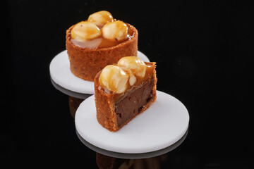 Front view, close up. Delicious cake against black background