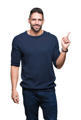 Young handsome man wearing sweater over isolated background with a big smile on face, pointing with hand and finger to the side looking at the camera.