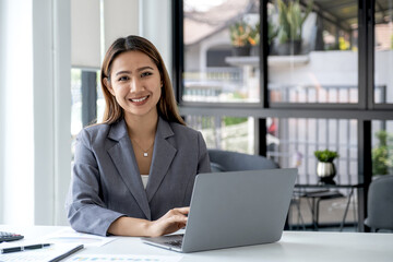 Businesswomen bookkeeper use laptop analysis the graph for Setting challenging business goals and ready to achieve target at home office