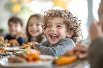 Obraz premium A Boy Laughing During a Family Meal