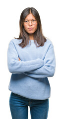 Young asian woman wearing winter sweater over isolated background skeptic and nervous, disapproving expression on face with crossed arms. Negative person.