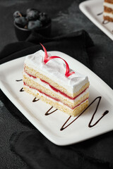 Strawberry Vanilla Cream Sponge Cake on White Plate with Black Background - Pop of Red Ribbon Garnish