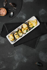 Elegant Presentation of Mussels in Cream Sauce with Dark and Moody Black Background