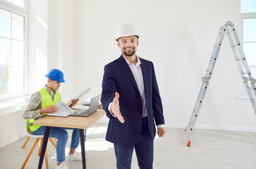 Portrait of a happy man, businessman, architect, engineer, or constructor, extending hand for a...